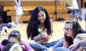 High school student smiling on a youth frontiers retreat sitting in a small group