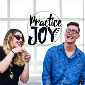 Two friends laughing while blowing bubbles with quote saying Practice Joy