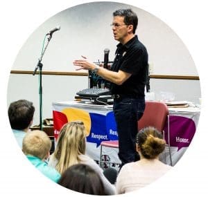 Joe Cavanaugh speaking to students on a microphone