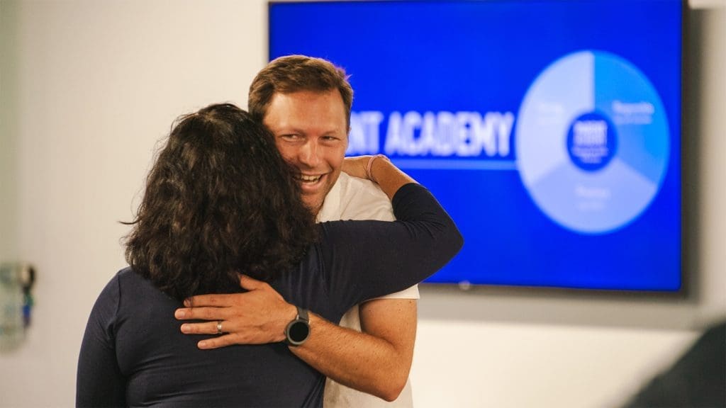 parent-academy-event-parents-hugging-in-front-of-keynote